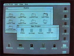 Lisa’s monitor screen shows a project-in-progress and the various computer functions available.