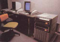 Photo 1: Two of the Xerox Alto personal computers. Each Alto processor is made of medium- and small-scale TTL integrated circuits, and is mounted in a rack beneath two 3-megabyte hard-disk drives. Note that the video displays are taller than they are wide and are similar to a page of paper, rather than standard television screen.